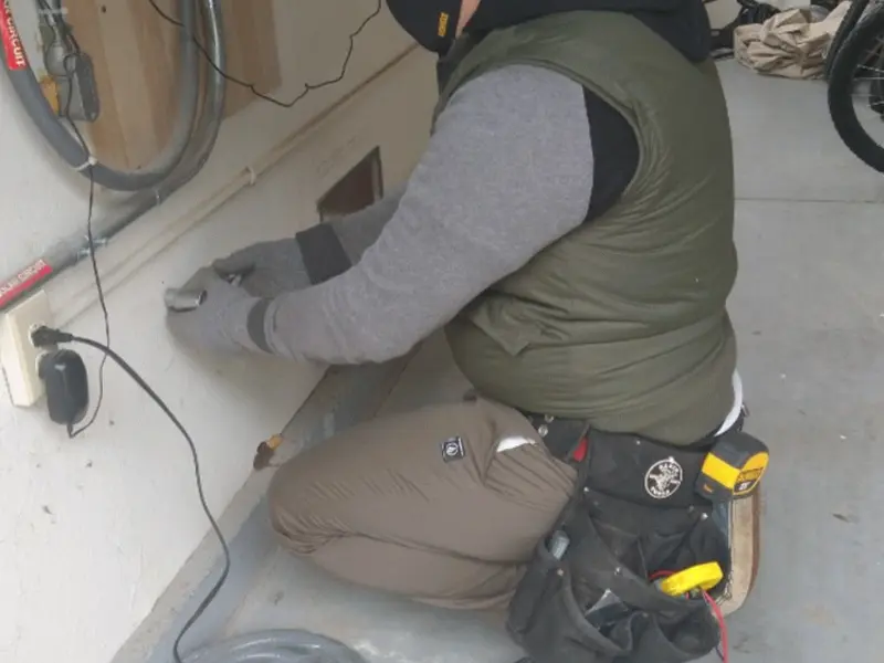 Electrician performing outlet wiring in a Burbank garage